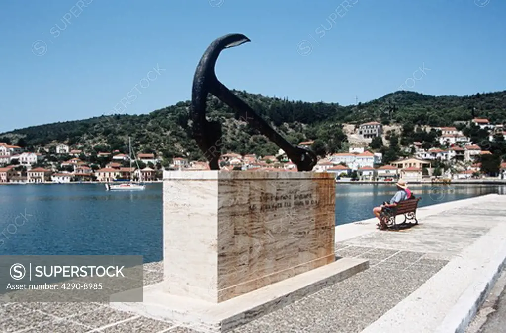 Anchor, tribute to those who have died and perished at sea, and harbour, couple sitting on seat, Vathi, Ithaca, Greece