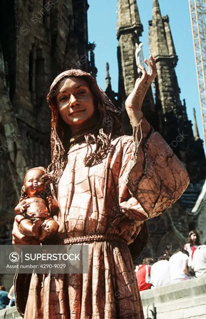 Street entertainer dressed as the Virgin Mary outside La Sagrada Familia, Barcelona, Spain