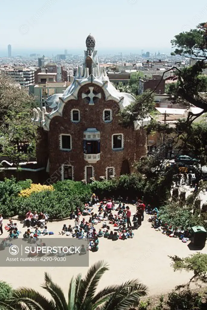 Party of schoolchildren on school trip in front of building, Guell Park, Barcelona, Spain