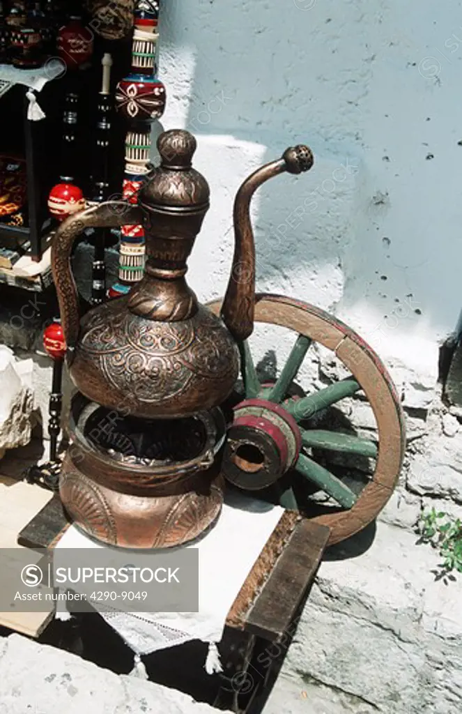Large Turkish style brass coffee pot and wheel for sale outside gift shop, Mostar, Bosnia Herzegovina