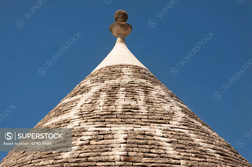 Conical dry stone roof of trulli house, with painted sun symbol, Alberobello, Bari province, Puglia region, Italy