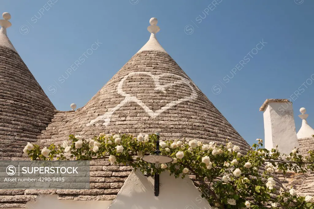 Conical dry stone roof of trulli house, with painted heart symbol, Alberobello, Bari province, Puglia region, Italy