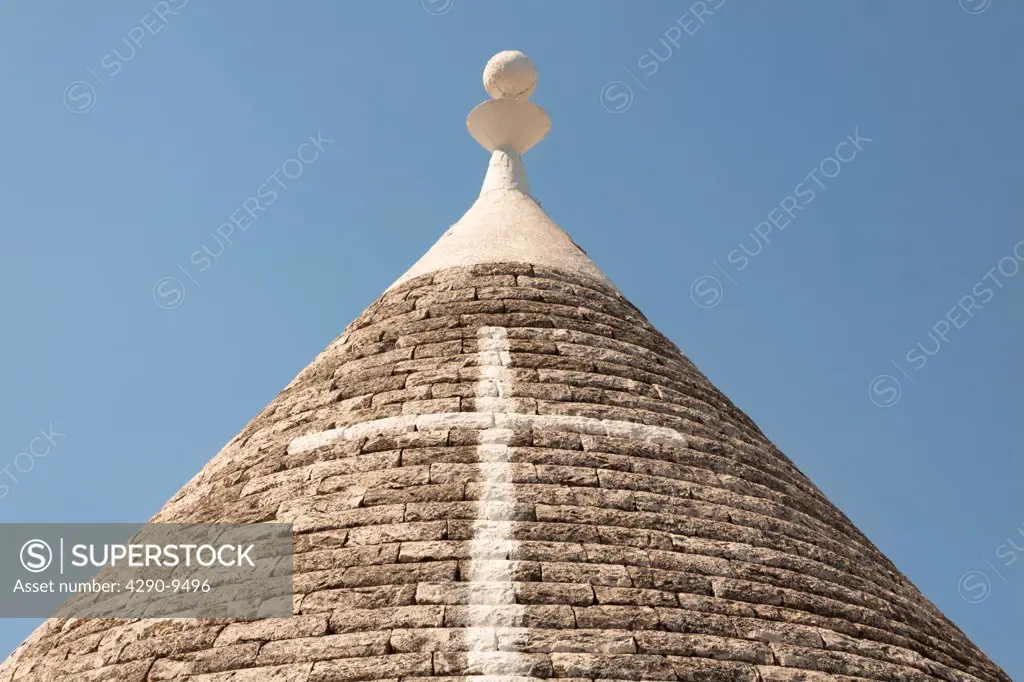 Conical dry stone roof of trulli house, with painted cross symbol, Alberobello, Bari province, Puglia region, Italy