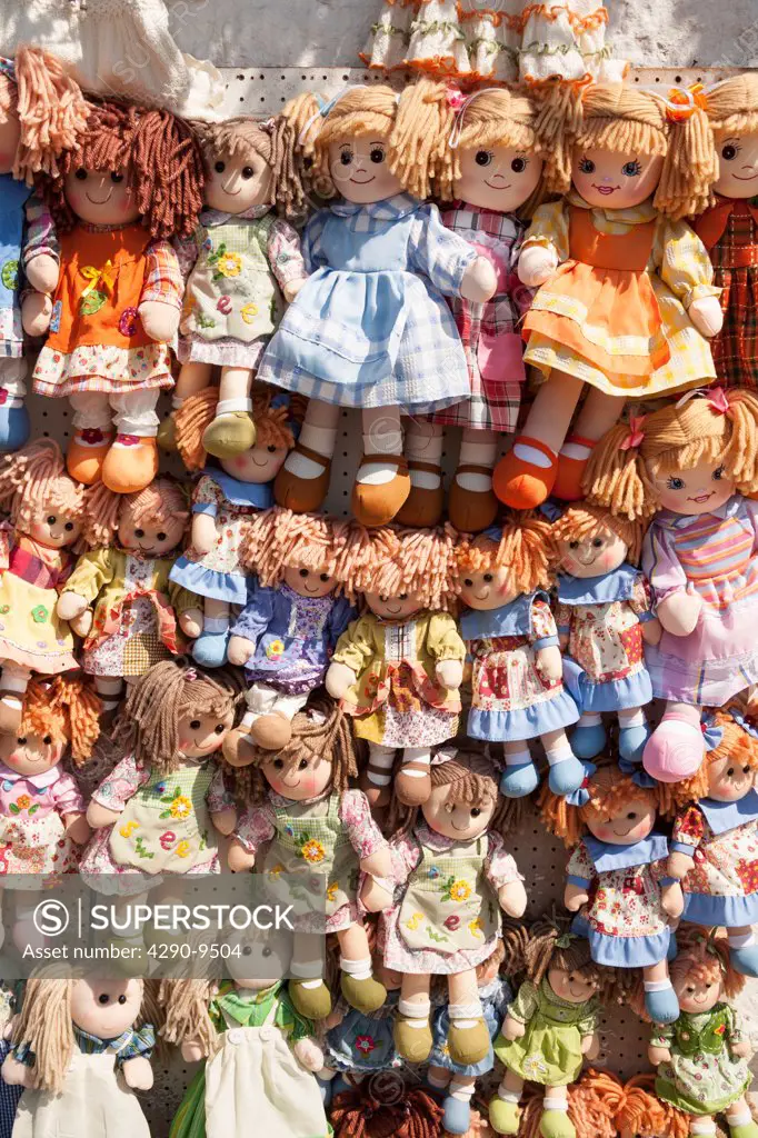 Colourful dolls for sale outside a shop, Alberobello, Italy