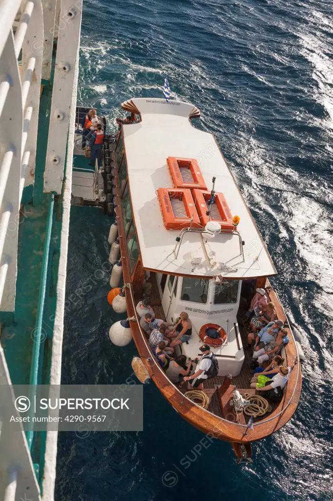Passengers disembarking from a tender and boarding a cruise ship, Santorini, Greece