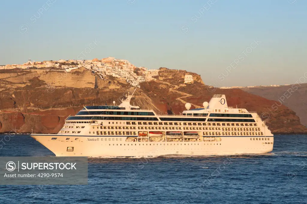 Clifftop village of Oia, and Nautica cruise ship, Santorini, Greece