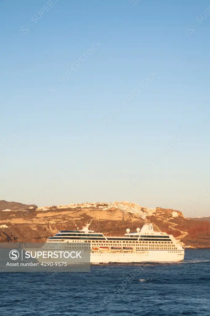 Nautica cruise ship passing the clifftop village of Oia, Santorini, Greece