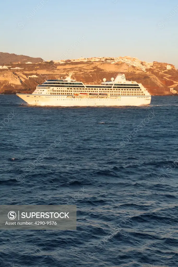 Nautica cruise ship passing the clifftop village of Oia, Santorini, Greece