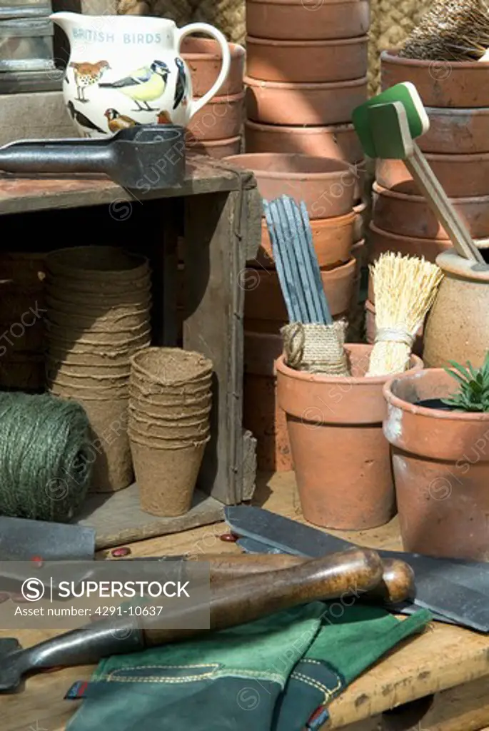 Greenhouse bench with terracota pots and sundry gardening items (Hartley Botanic Ltd/Chelsea Flower Show 2008)