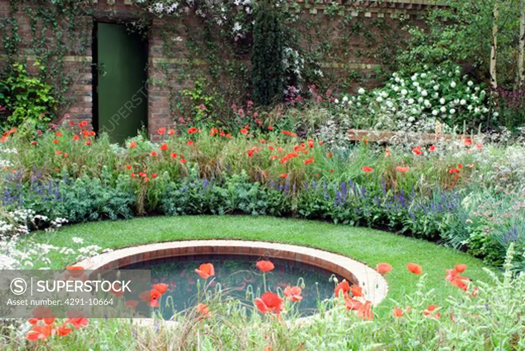 Wild poppies and sheep's parsley surrounding circular pool in walled garden (The Largest Room in the House - Leeds City Council/Designer: Denise Preston - Chelsea Flower Show 2008)