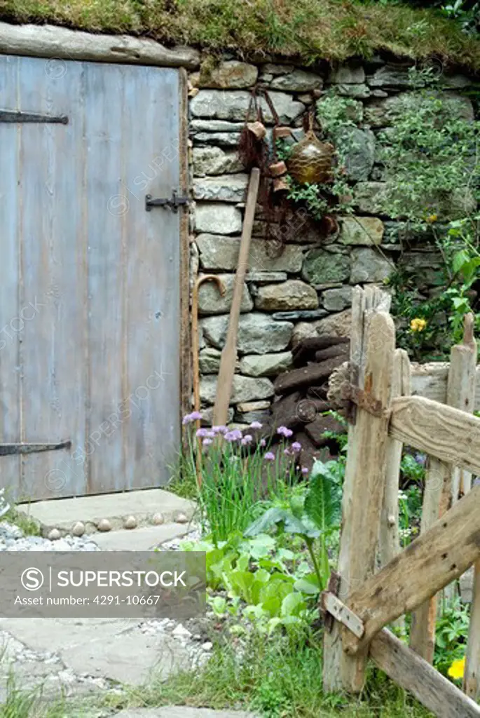 Shetland croft with simple vegetable garden and peat slabs for fuel (Motor Neurone Disease/Shetland Croft House Garden - Motor Neurone Disease/Designer: Sue Hayward Garden Designs - Chelsea Flower Show 2008)