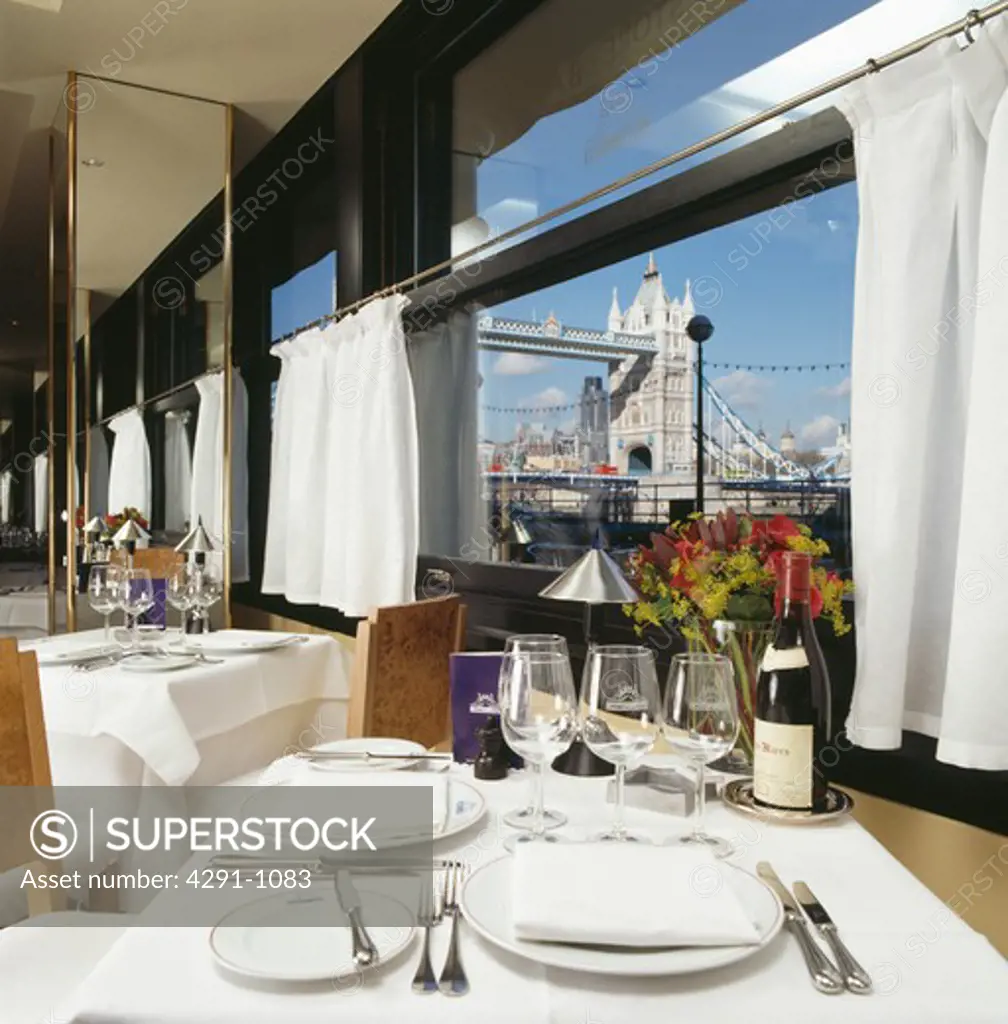 Table set for lunch in front of window at the Pont de la Tour restaurant in London with view of Tower Bridge