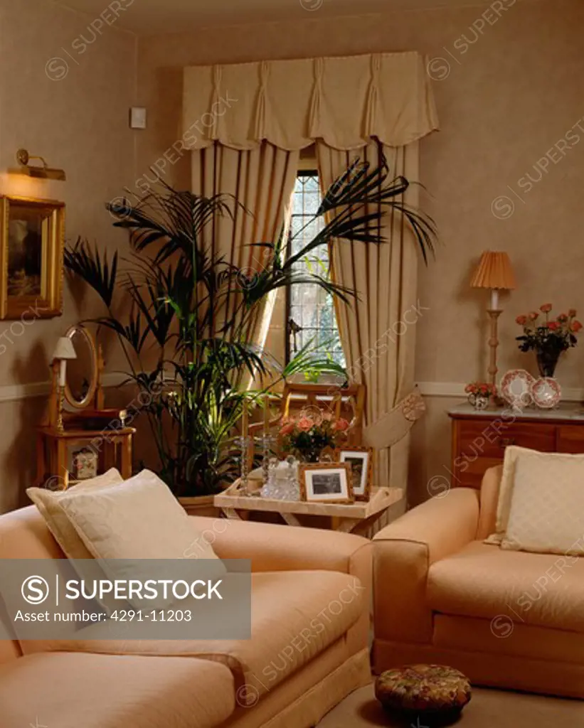 Cream curtains and sofas in traditional living room