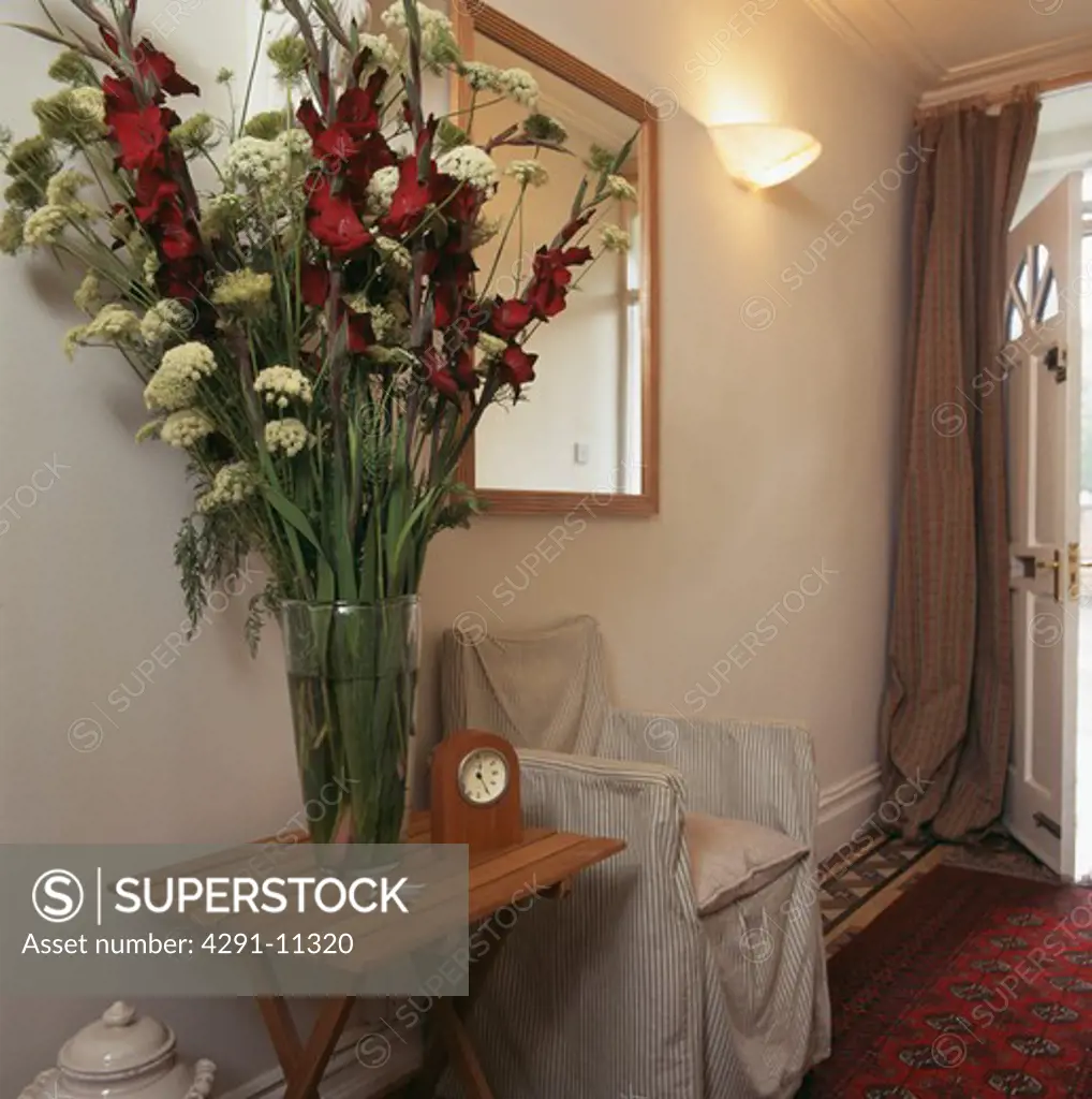 Flower arrangement on console table in traditional hall