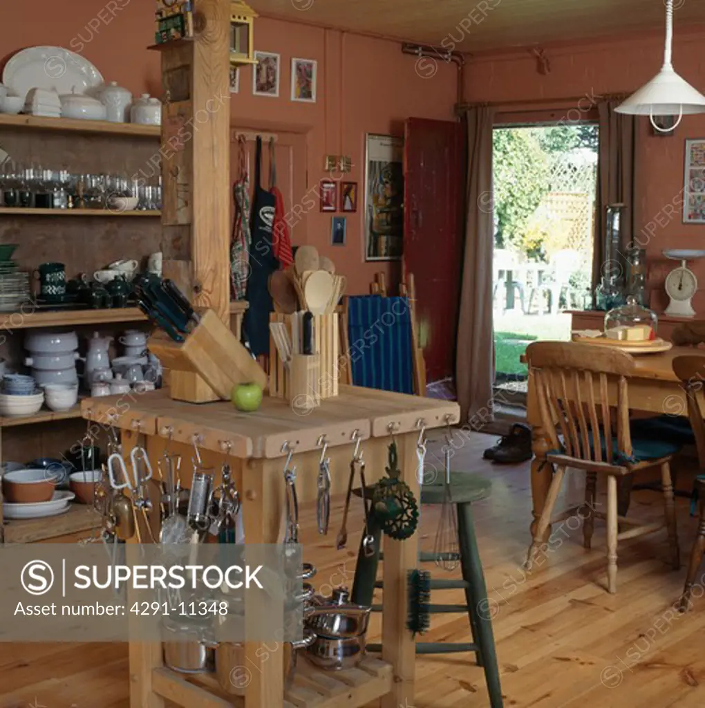 Metal utensils stored on butcher's block in country kitchen