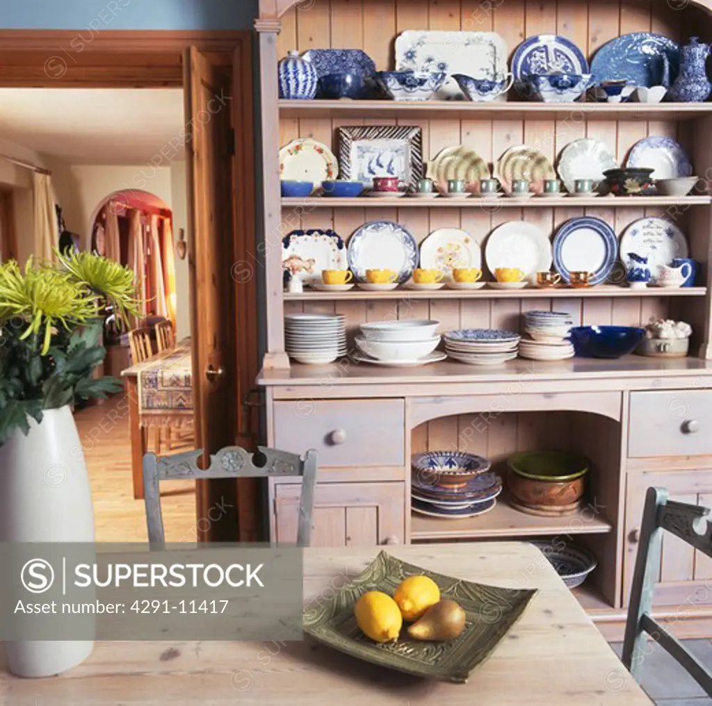 Collection of blue crockery on limewashed dresser in country kitchen