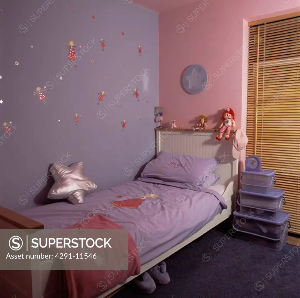 Mauve and pink walls above white bed with mauve bedlinen in economy-style child's bedroom with plastic storage boxes