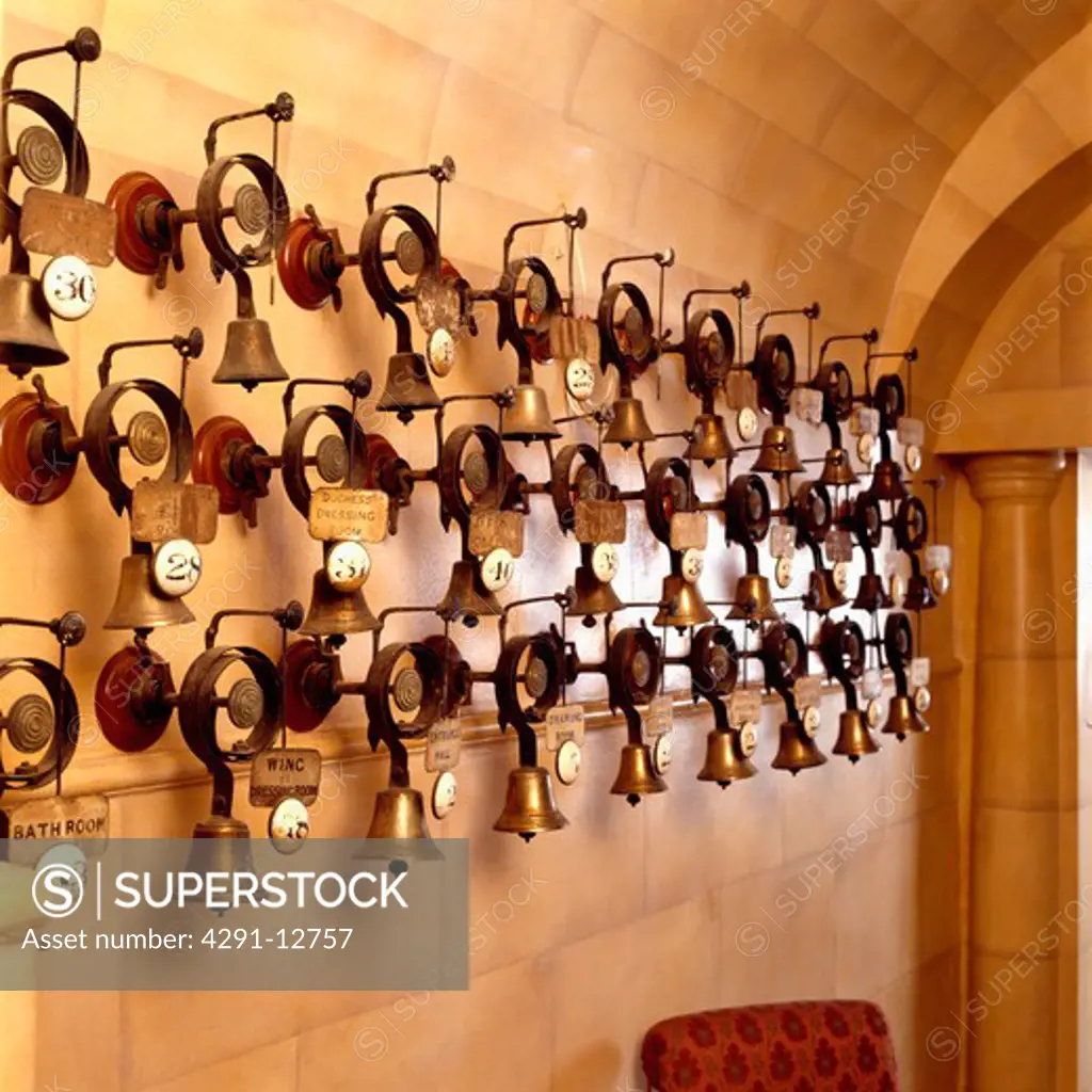 Row of Edwardian room bells on wall of country hall