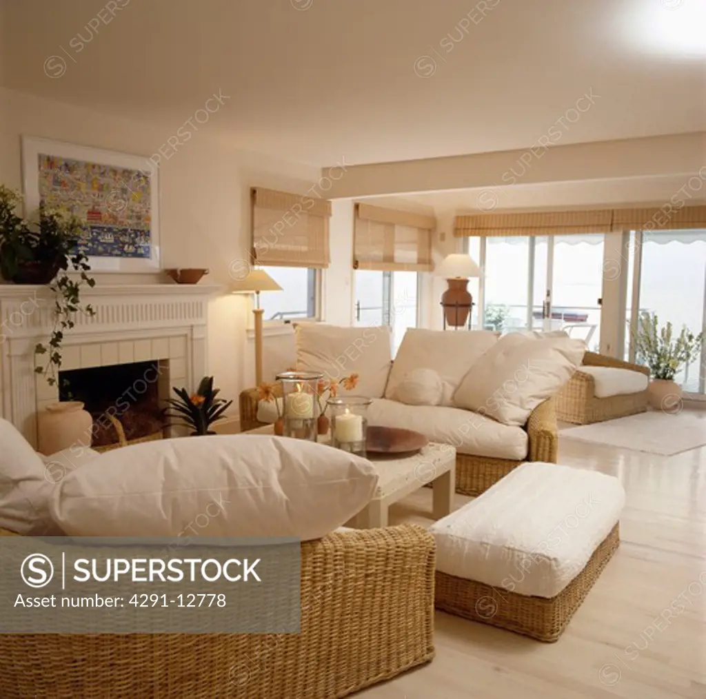 Cream cushions on wicker sofas in cream coastal living room