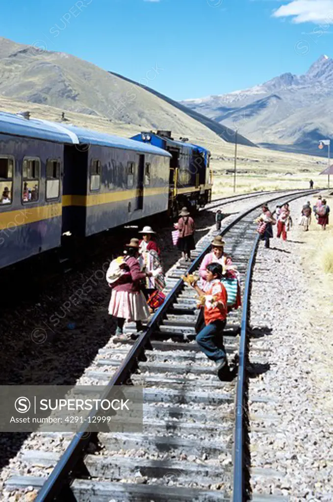 Women selling gifts on railway track, near La Raya, Puno to Cusco Perurail train journey, Peru