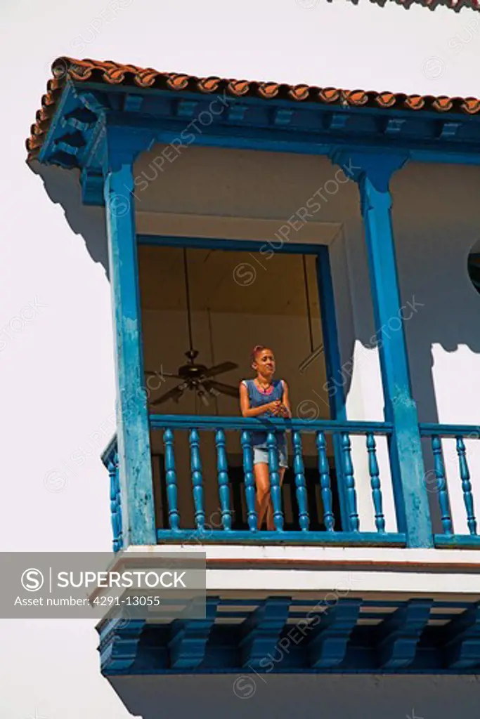 Woman on balcony of the Ayuntamiento, Town Hall, Parque Cespedes, Santiago de Cuba, Cuba