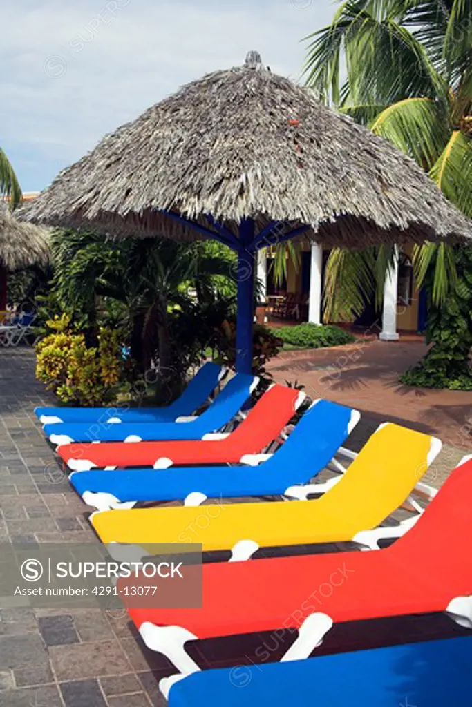 Sun umbrella and sun beds on a poolside patio, near Trinidad, Sancti Spiritus Province, Cuba