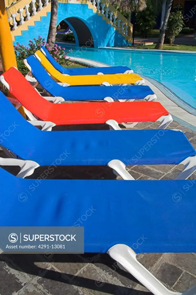 Several colourful sun beds on a poolside patio, near Trinidad, Sancti Spiritus Province, Cuba