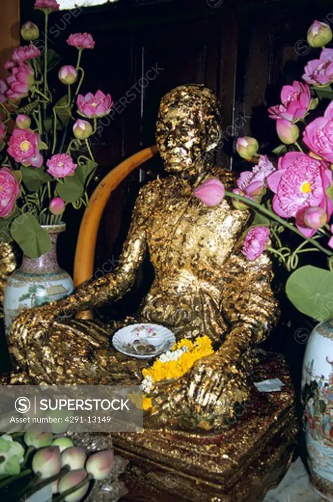 Statues, offerings, Temple of the Golden Buddha, Wat Traimit (also known as Wat Trimitr), Bangkok, Thailand
