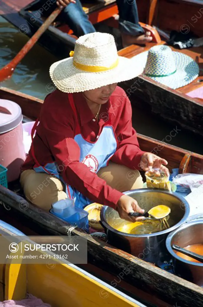 Woman selling food, Damnoen Saduak floating market, Ratchaburi Province, near Bangkok, Thailand