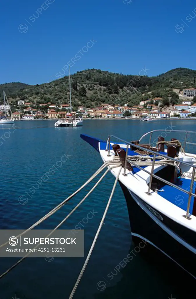 Bow of moored yacht in harbour and Vathi town behind, Vathi, Ithaca, Greece