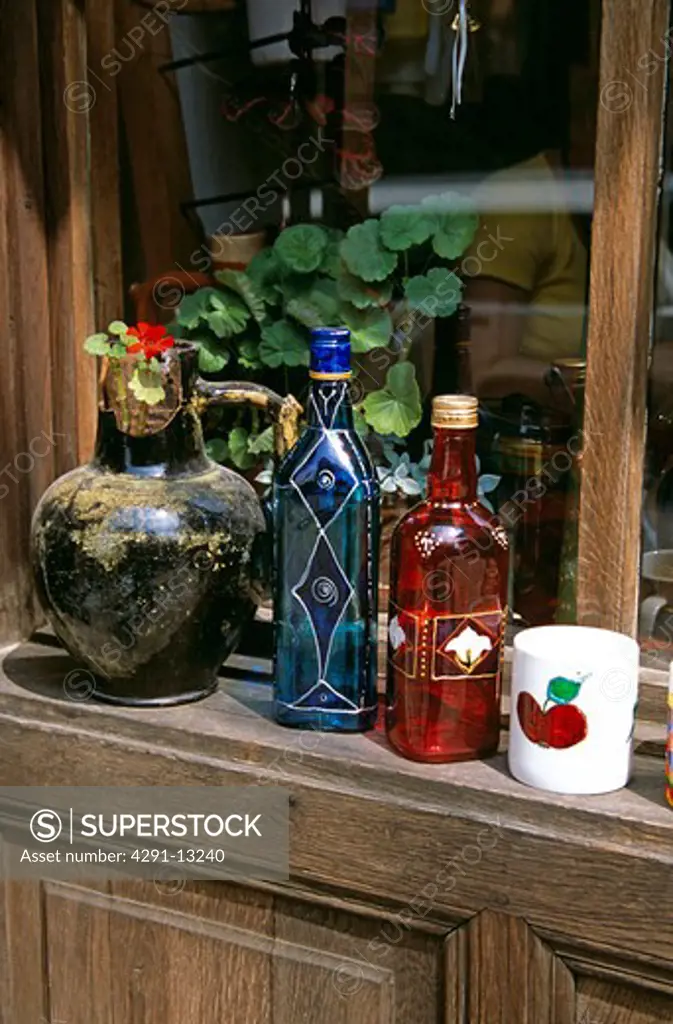 Display of hand painted glass bottles, mug and pot outside gift and craft shop, Veliko Tarnovo, Bulgaria