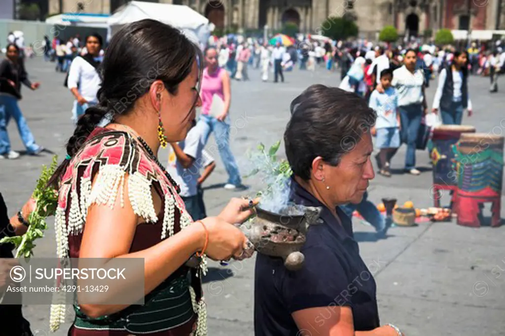 Female Mexican Indian practising traditional religious healing ceremony in Zocalo