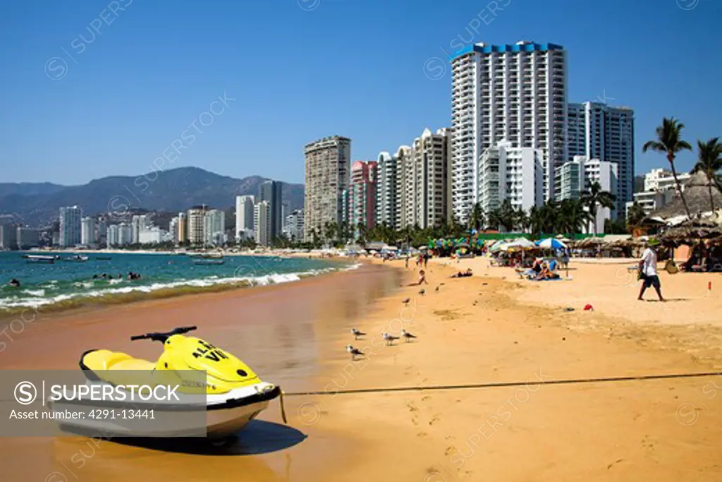 Jetski on beach in front of tall hotels and modern condominiums at Acapulco, Guerrero State