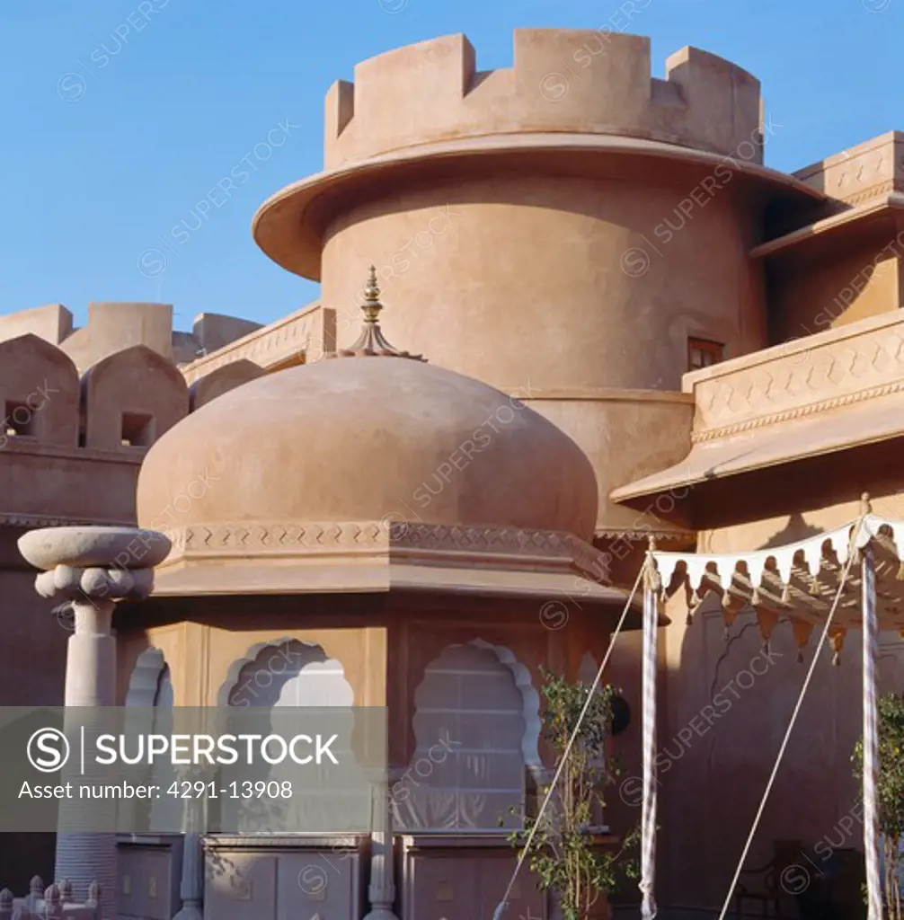 Dome and turret on old sandstone fort now the Rajvilas Hotel near Jaipur in Rajastan