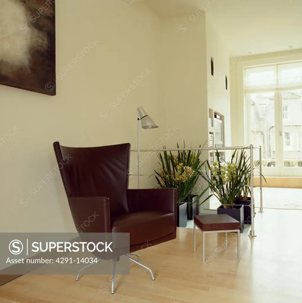 Montis black leather swivel armchair on maple wood flooring in modern city livingroom