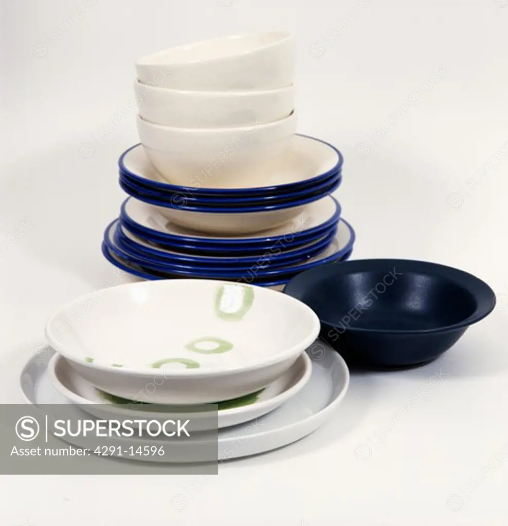 Close-up of stack of white and dark blue bowls