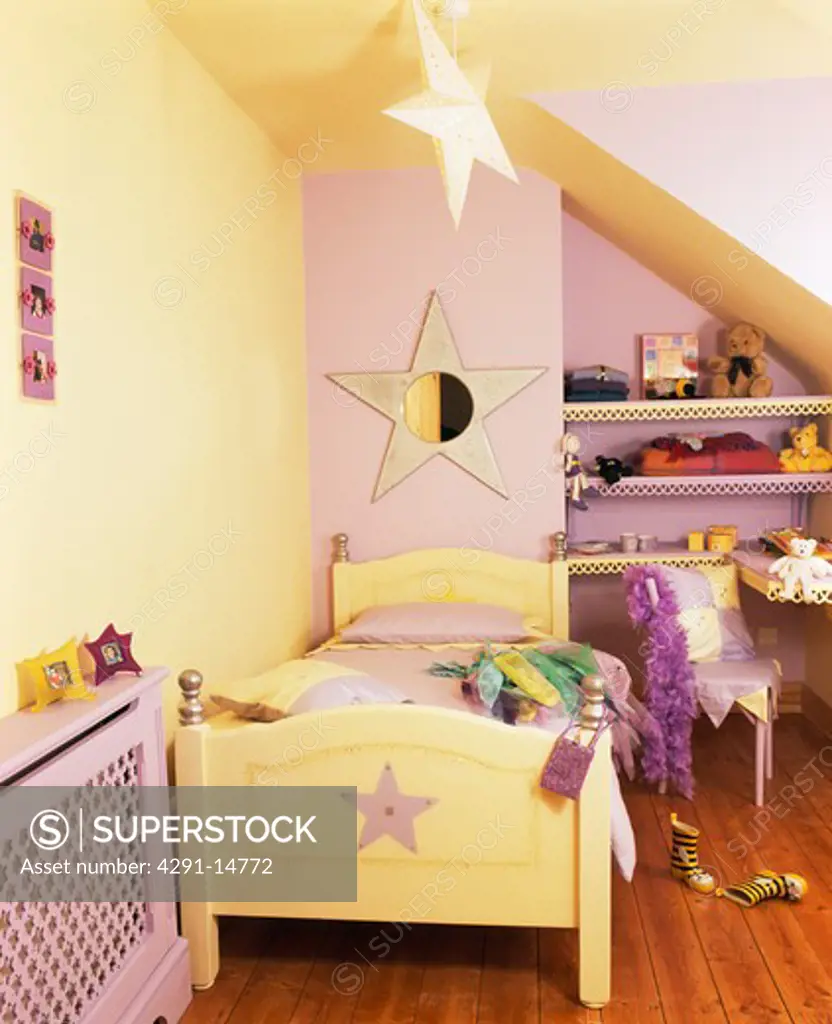 Star-themed painted wooden bed in mauve and cream child's bedroom