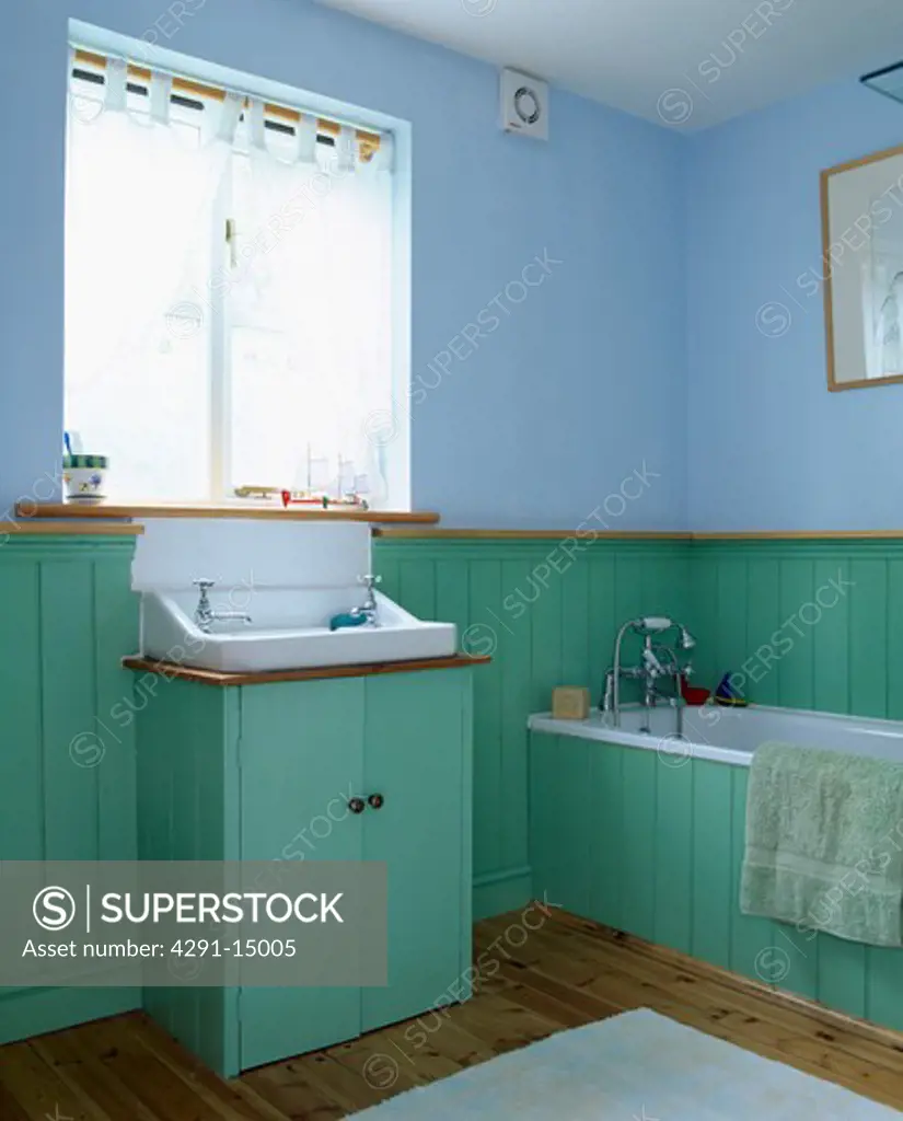 Turquoise tongue and groove panelling in pastel blue bathroom
