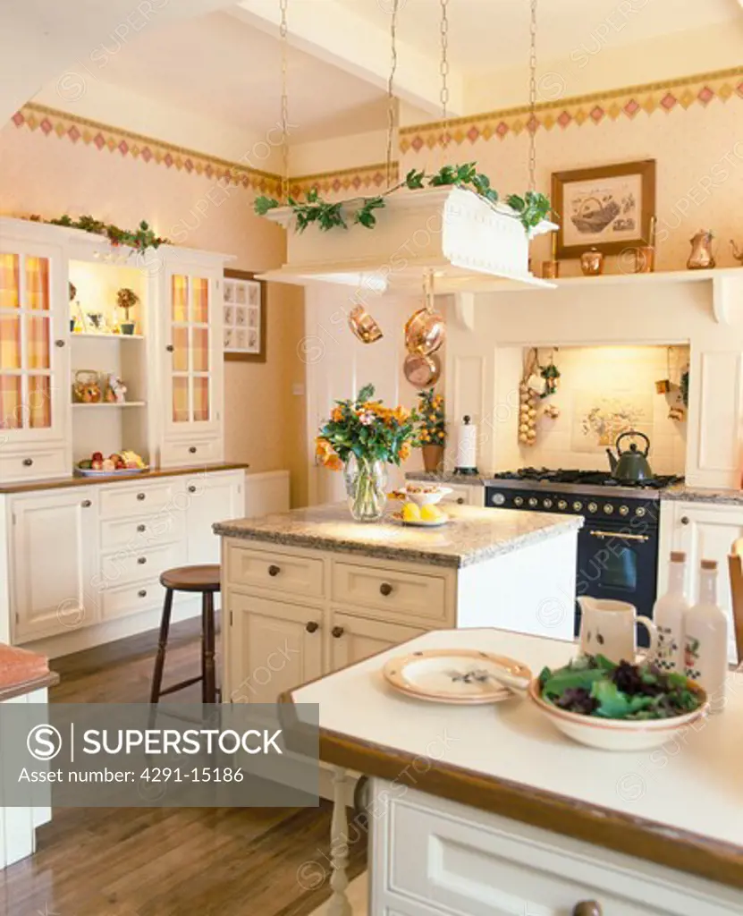 Suspended frame above island unit in cream eighties-style kitchen