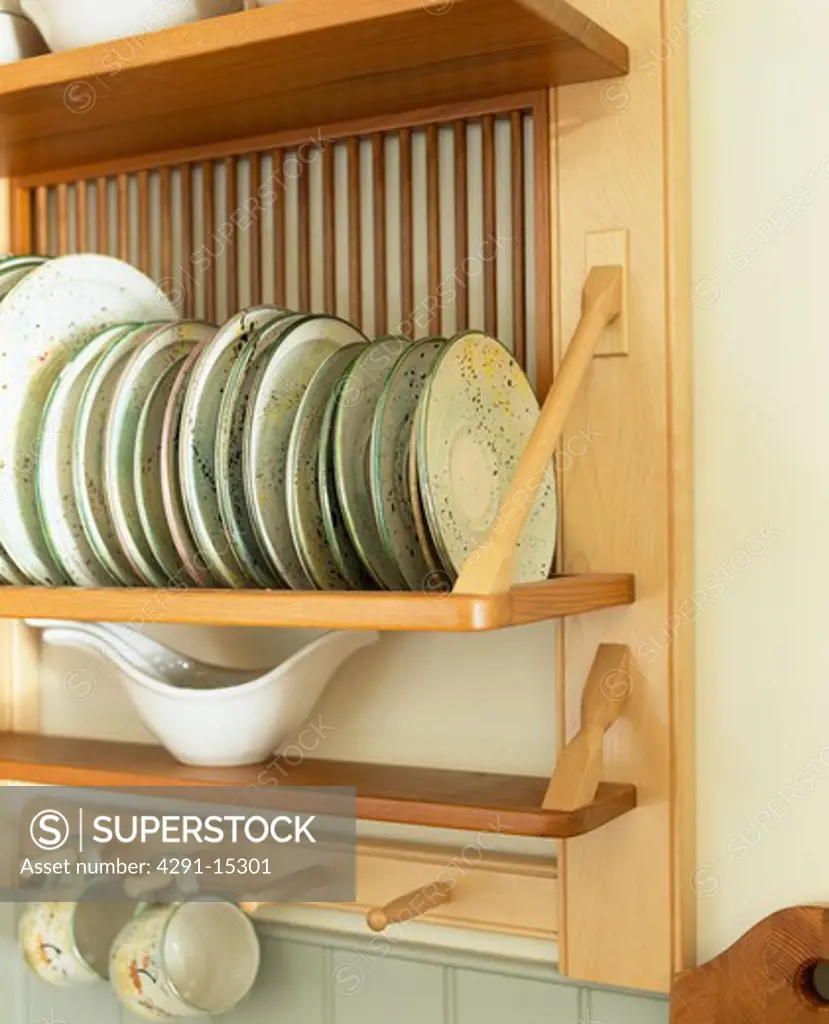 Close-up of plates on wooden plate rack