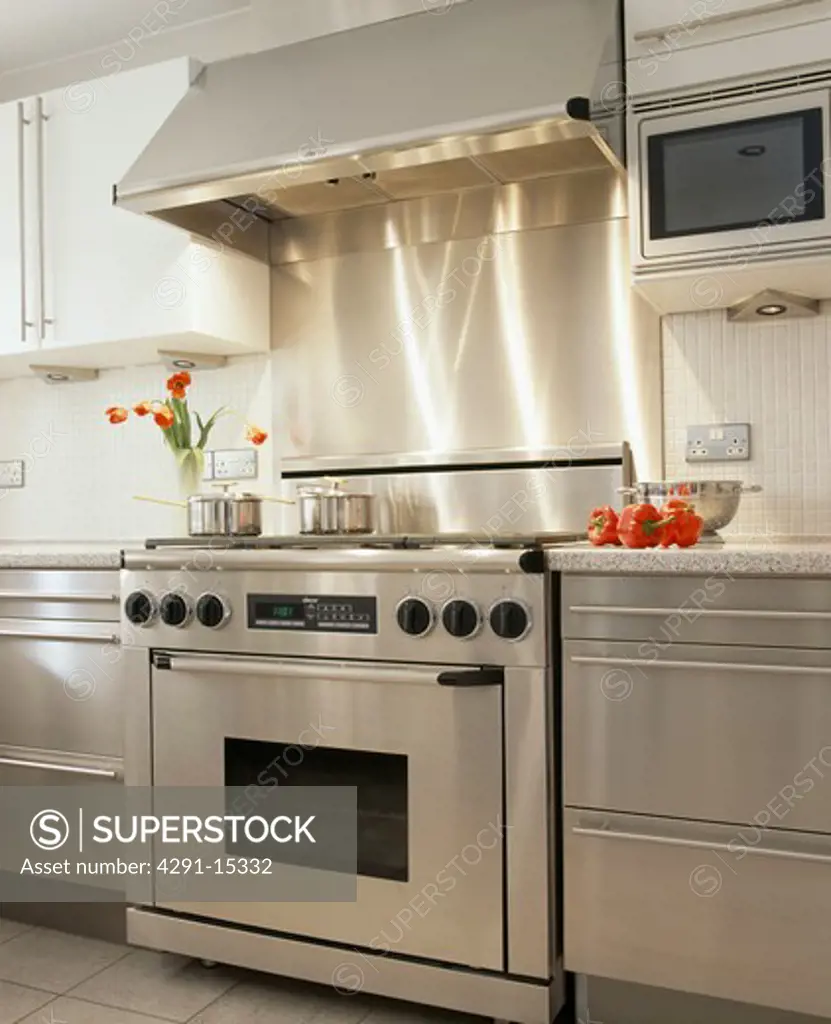 Stainless steel range oven and fitted units in modern kitchen