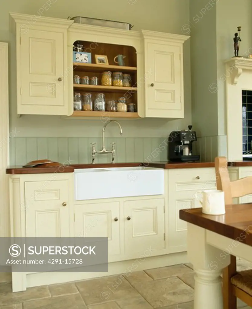 Belfast sink in cream fitted unit in traditional country kitchen