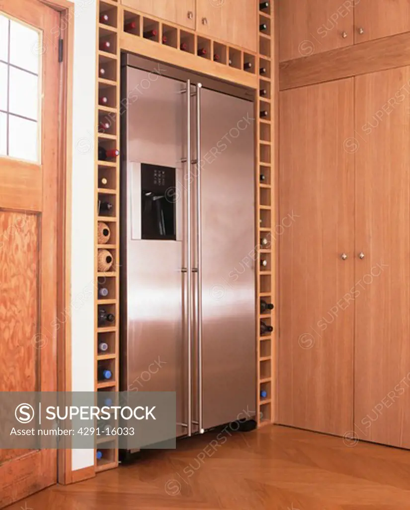 Large stainless steel American-style freezer in modern kitchen with fitted wine storage