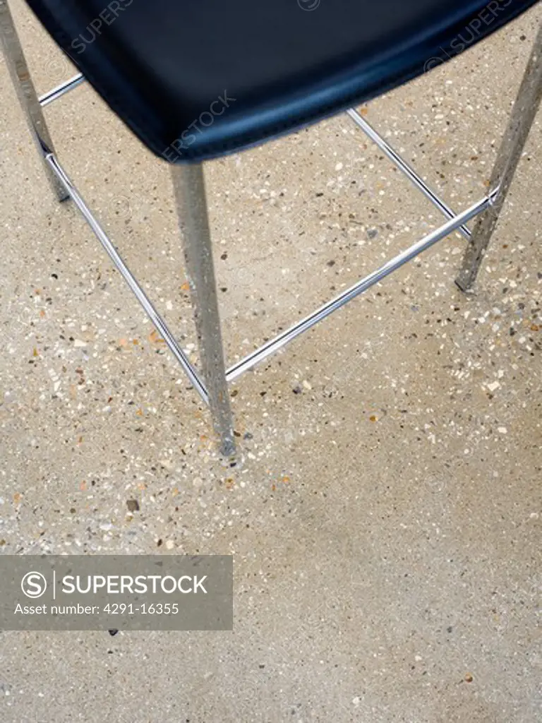 Close-up of stool on concrete flooring