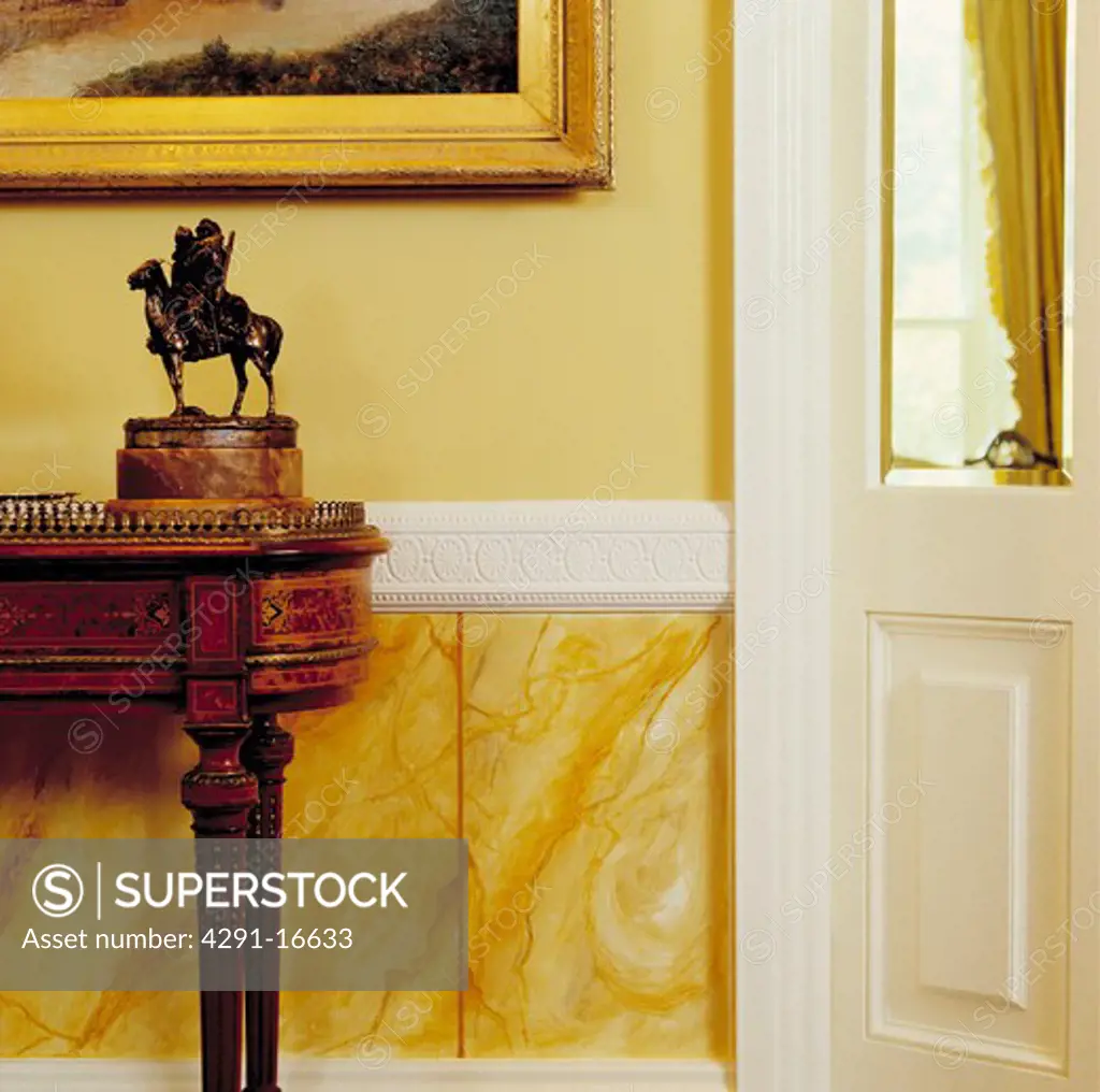 Marbling paint-effect dado in traditional hall with statue on antique table