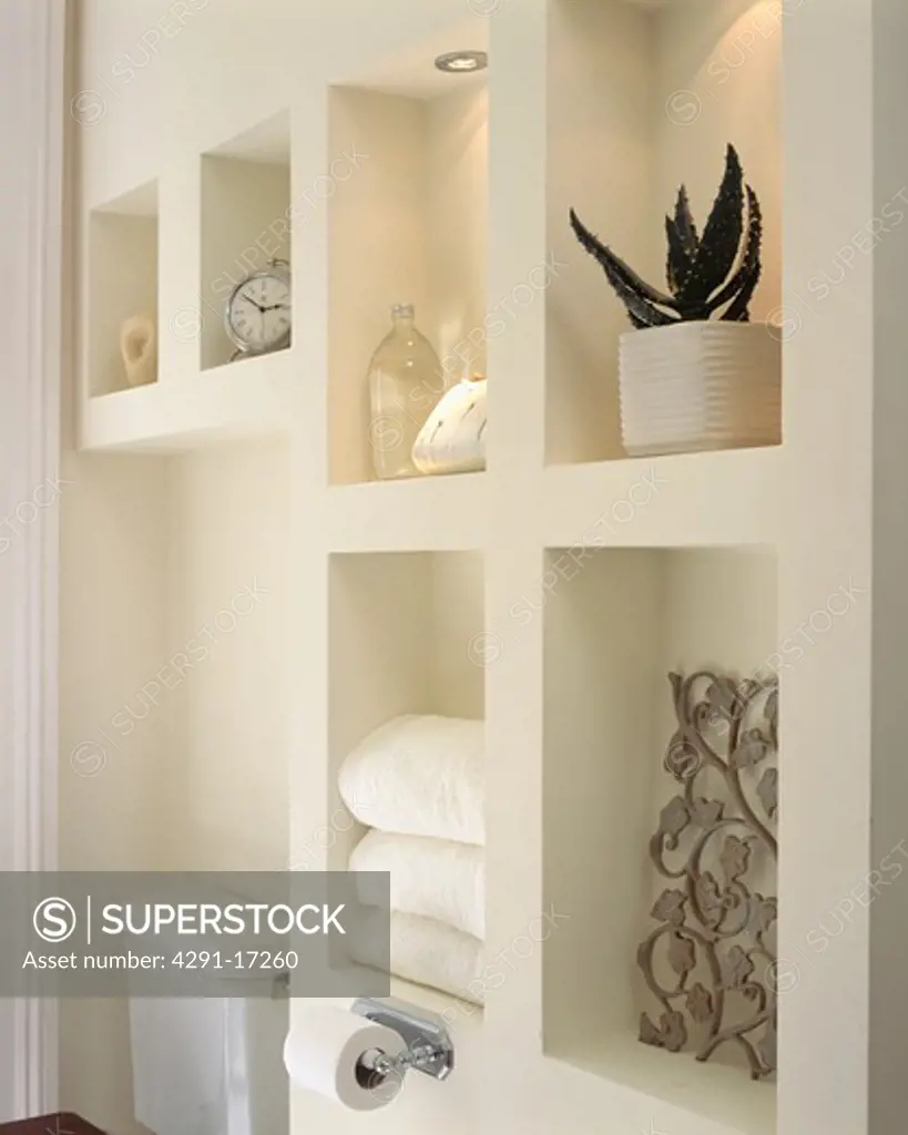 Close up of modern alcove shelving in white bathroom
