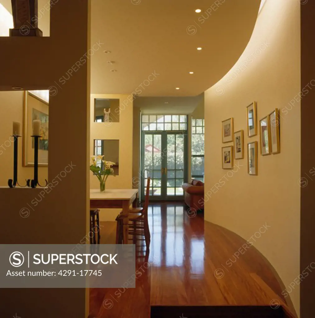 Polished wooden flooring in modern openplan hall dining room