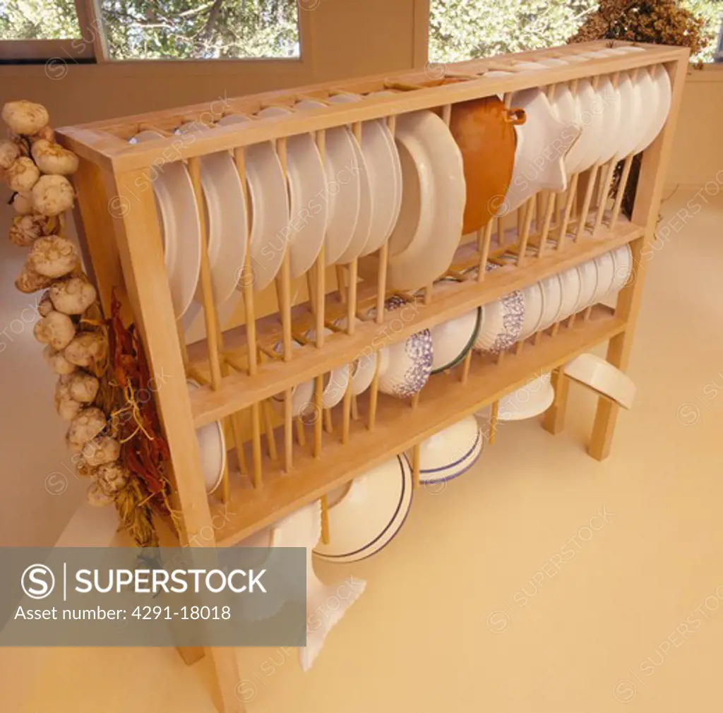 Close-up of white plates on suspended wooden rack