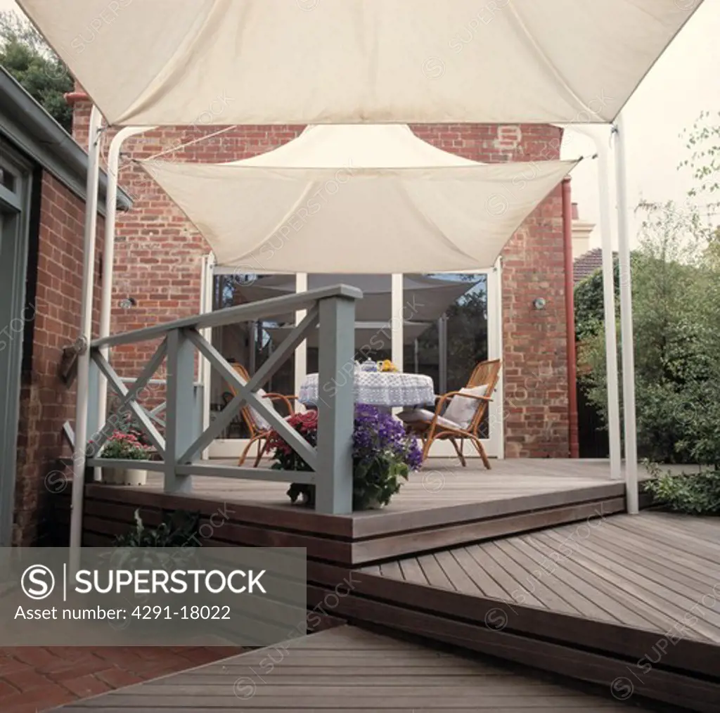 Architectural decked terrace with white canvas canopies