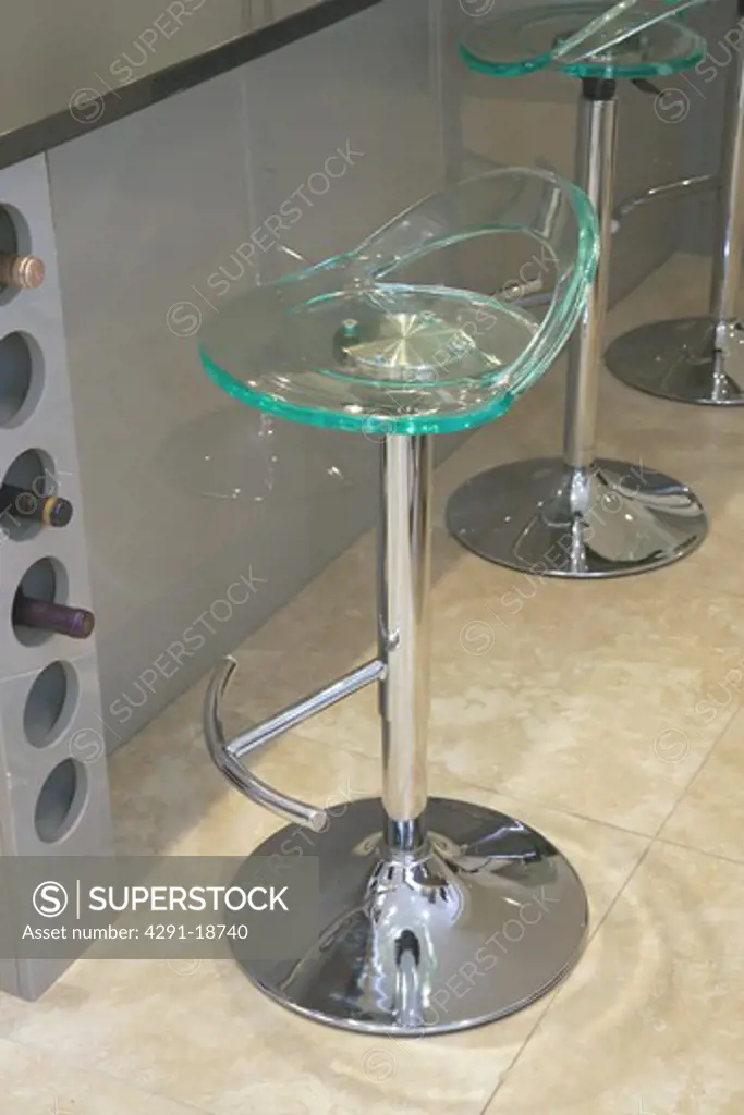 Close-up of modern perspex and chrome kitchen bar stools